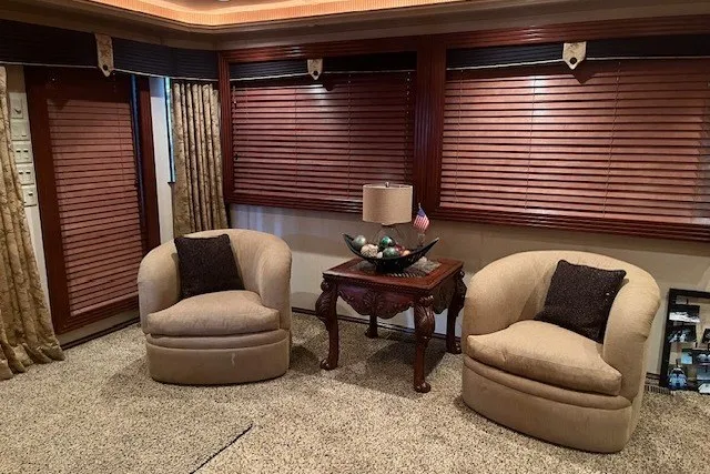 Slide: The Image of Cozy living room with beige chairs, wooden blinds, and elegant decor. - 10