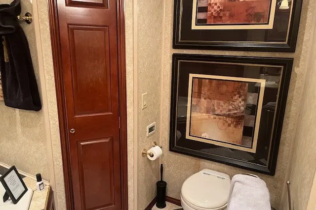 Slide: The Image of Luxurious bathroom with framed art, wooden door, and modern fixtures in a 2006 Fantasy model. - 52