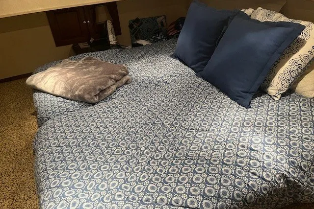Slide: The Image of Cozy bedroom with blue patterned bedding, plush pillows, and a soft blanket. - 45