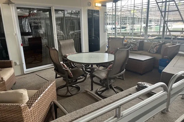 Slide: The Image of Spacious outdoor seating area on a 2006 Fantasy 20x100 houseboat with wicker furniture. - 3