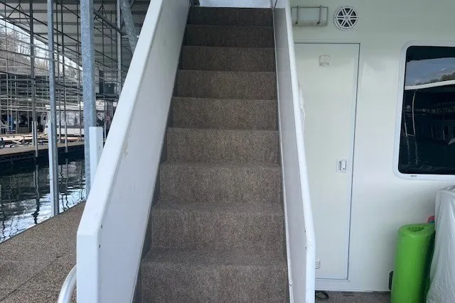 Slide: The Image of Staircase on a 2006 Fantasy 20x100 houseboat, docked at a marina. - 60