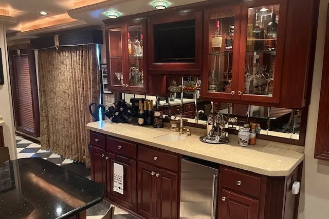 Slide: The Image of Luxurious RV interior with wooden cabinetry, countertop, and built-in bar area, Fantasy 20x100, 2006 model. - 16