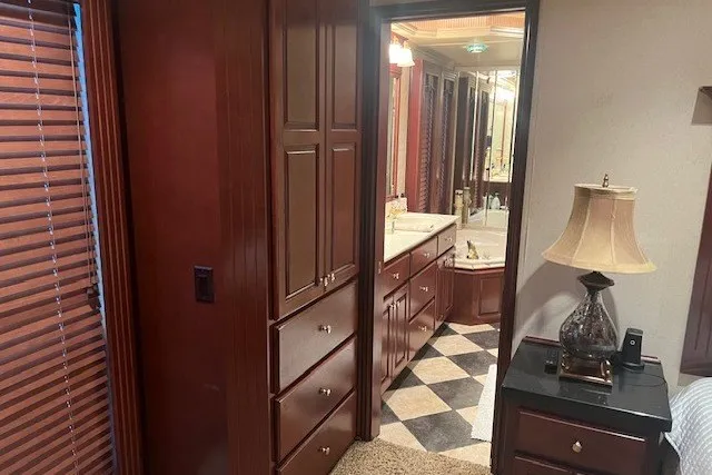 Slide: The Image of Luxurious RV interior with wooden cabinets, elegant bathroom, and stylish decor, Fantasy 20x100, 2006 model. - 49