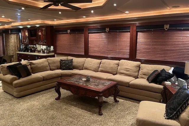Slide: The Image of Luxurious living room in a 2006 Fantasy 20x100 houseboat with plush sectional sofa. - 7