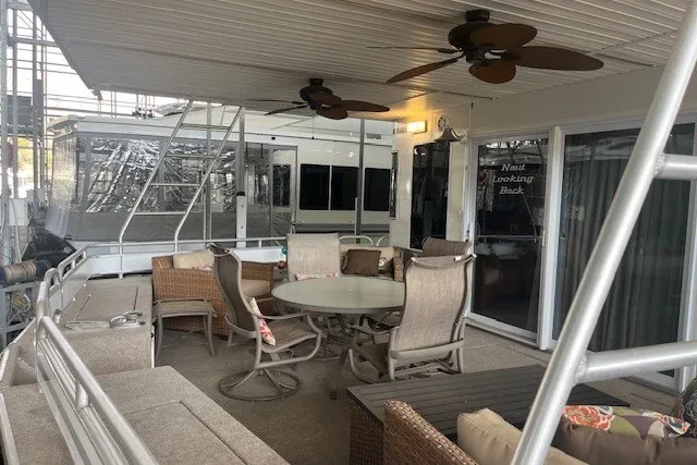 Slide: The Image of Spacious deck on 2006 Fantasy 20x100 houseboat with outdoor seating and ceiling fans. - 2