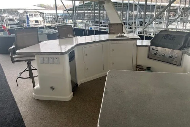 Slide: The Image of Luxurious outdoor kitchen on a 2006 Fantasy 20x100 houseboat with seating and grill. - 68