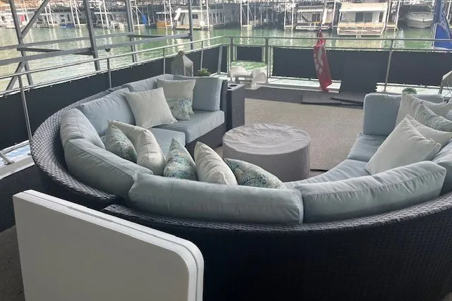 Slide: The Image of Luxurious circular outdoor seating on a 2006 Fantasy 20x100 houseboat, docked at a marina. - 64