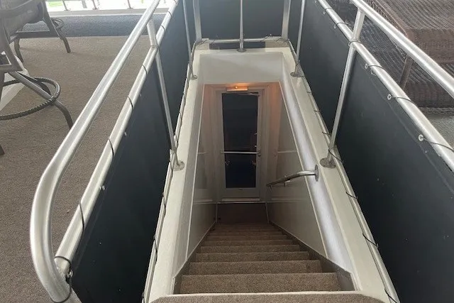 Slide: The Image of Staircase with metal railings leading to a door, inside a 2006 Fantasy 20x100 model. - 24