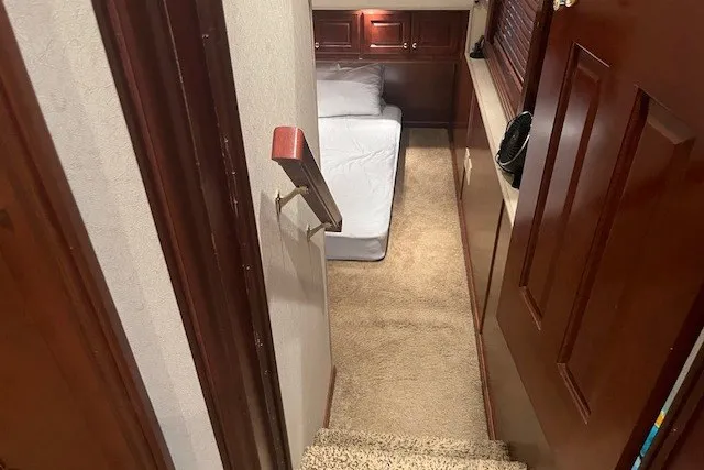 Slide: The Image of Narrow staircase leading to a cozy bedroom with wooden accents in a 2006 Fantasy 20x100 model. - 41
