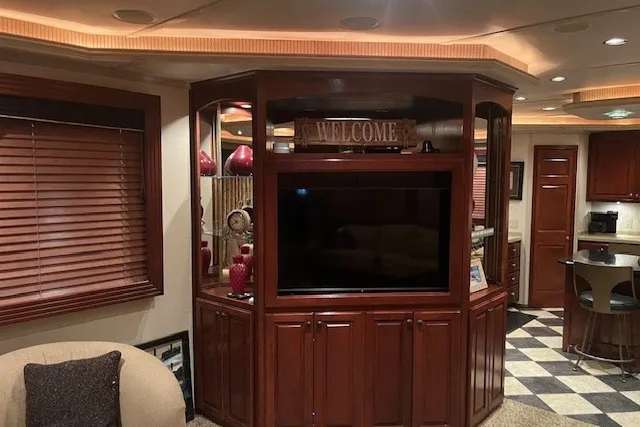 Slide: The Image of Luxurious RV interior with wood cabinetry, TV, and cozy seating, Fantasy 20x100 model, 2006. - 9