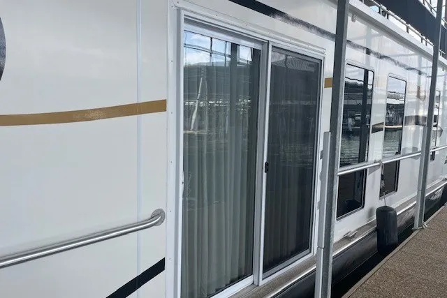 Slide: The Image of 2006 Fantasy 20x100 houseboat with sliding glass doors and dockside view. - 5