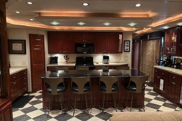 Slide: The Image of Luxurious kitchen in a 2006 Fantasy 20x100 houseboat with modern appliances and elegant design. - 18