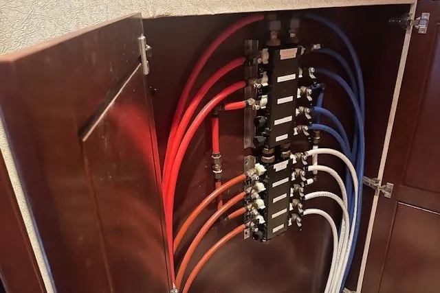 Slide: The Image of Color-coded plumbing manifold system inside a wooden cabinet, Fantasy 20x100 model, 2006. - 28