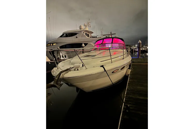 Slide: The Image of 2003 Sea Ray 380 Sundancer yacht docked at marina with vibrant pink lighting. - 29