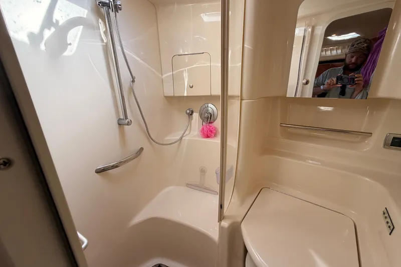 Slide: The Image of Bathroom interior of 2003 Sea Ray 380 Sundancer yacht, featuring shower and mirror. - 23