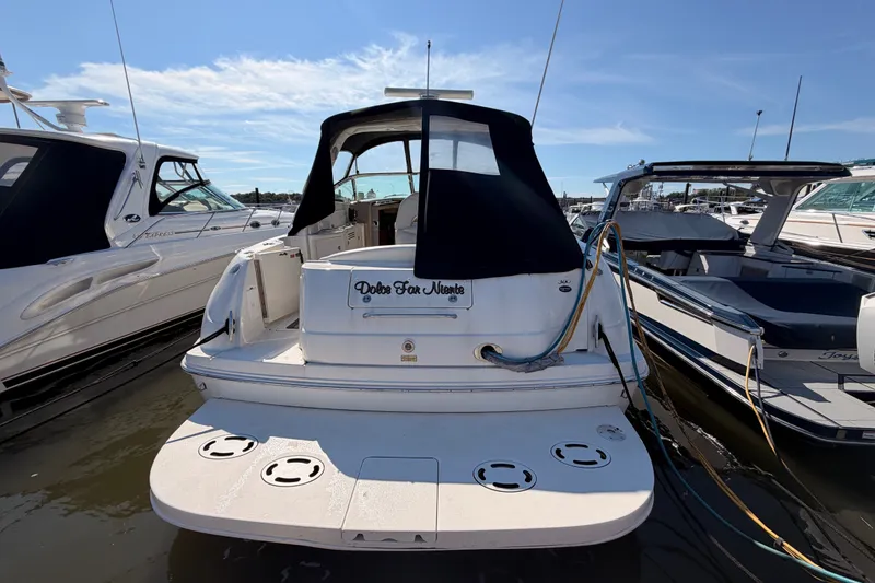 Slide: The Image of 2003 Sea Ray 380 Sundancer docked at marina under clear blue sky. - 7
