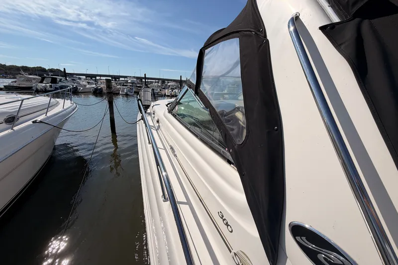 Slide: The Image of 2003 Sea Ray 380 Sundancer docked at marina under clear blue sky. - 6