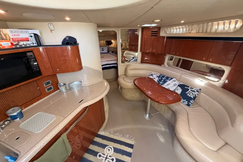 Slide: The Image of Luxurious interior of 2003 Sea Ray 380 Sundancer yacht with elegant seating and kitchenette. - 16