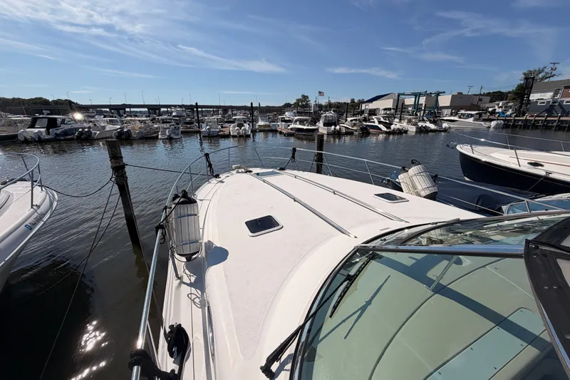 Slide: The Image of 2003 Sea Ray 380 Sundancer docked at a marina under a clear blue sky. - 5