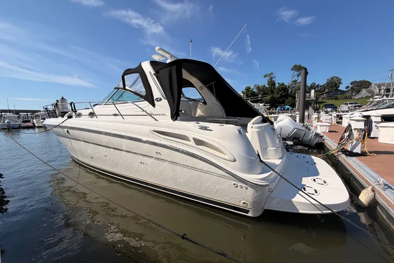 The Image of 2003 Sea Ray 380 Sundancer yacht docked at marina under clear blue sky. - 0