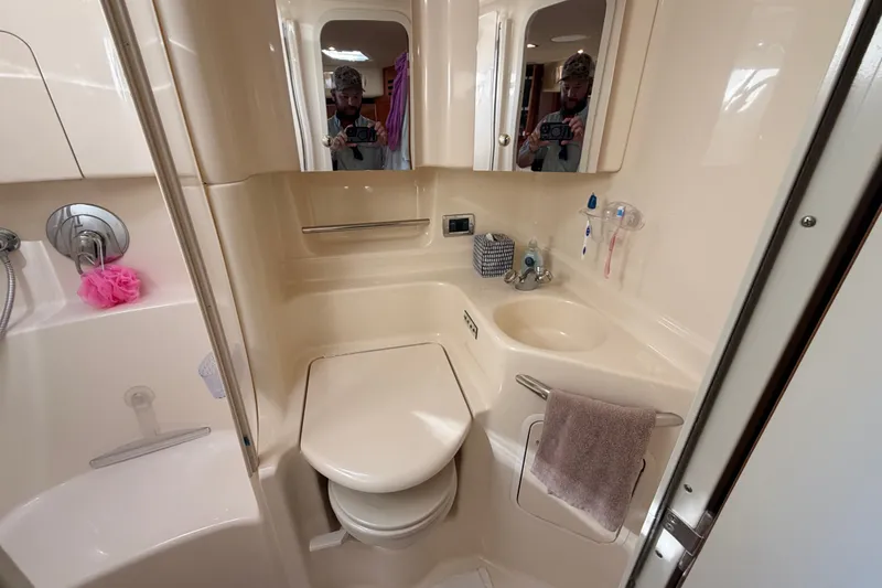 Slide: The Image of Bathroom interior of 2003 Sea Ray 380 Sundancer yacht, featuring sink, toilet, and shower. - 22