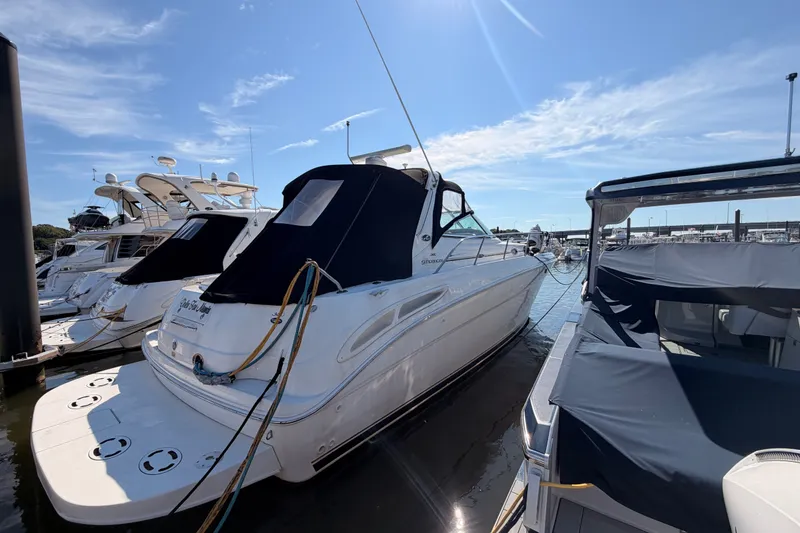 Slide: The Image of A 2003 Sea Ray 380 Sundancer docked in a marina, surrounded by other boats. - 1
