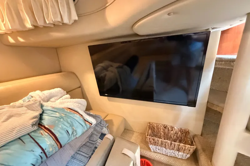 Slide: The Image of Interior of 2003 Sea Ray 380 Sundancer with TV, bedding, and storage basket. - 21