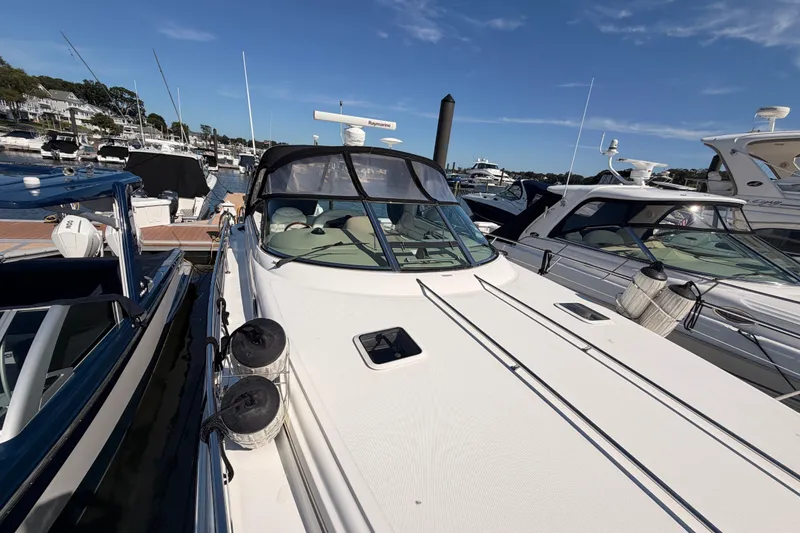 Slide: The Image of 2003 Sea Ray 380 Sundancer yacht docked at marina under clear blue sky. - 4