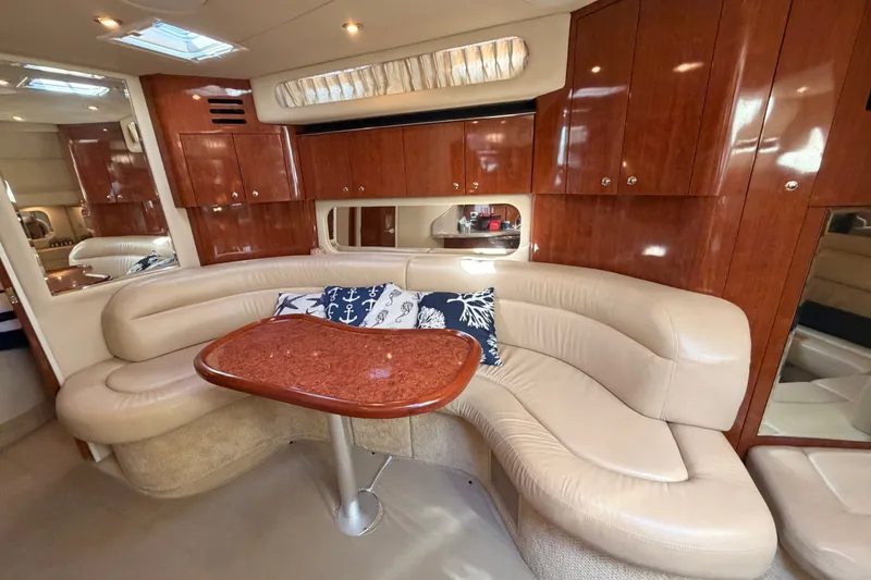 Slide: The Image of Luxurious interior of 2003 Sea Ray 380 Sundancer with plush seating and wooden cabinetry. - 20