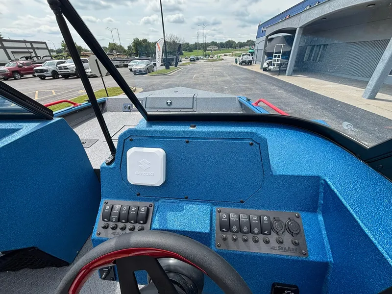 Slide: The Image of The image shows the cockpit of a 2027 SeaArk Protege 200 boat with a blue dashboard. - 19