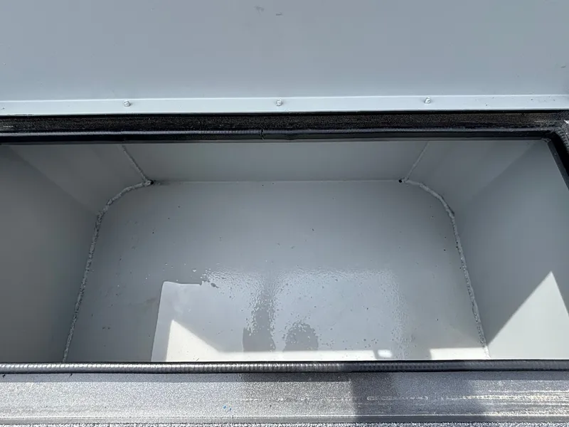 Slide: The Image of An empty, rectangular storage compartment with a metal frame and gray interior. - 14