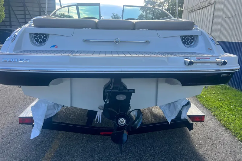 Slide: The Image of The image shows the rear of a 2027 Crownline 200 SS boat on a trailer. - 2
