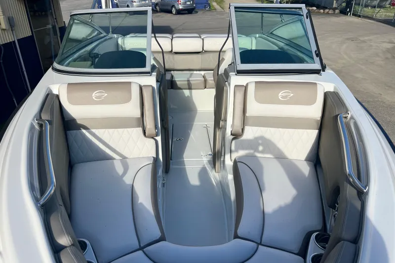 Slide: The Image of 2027 Crownline 200 SS boat interior with beige seating and open windshield. - 9