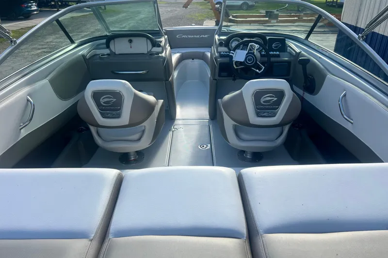 Slide: The Image of Interior of a 2027 Crownline 200 SS boat, featuring sleek seating and modern dashboard. - 8