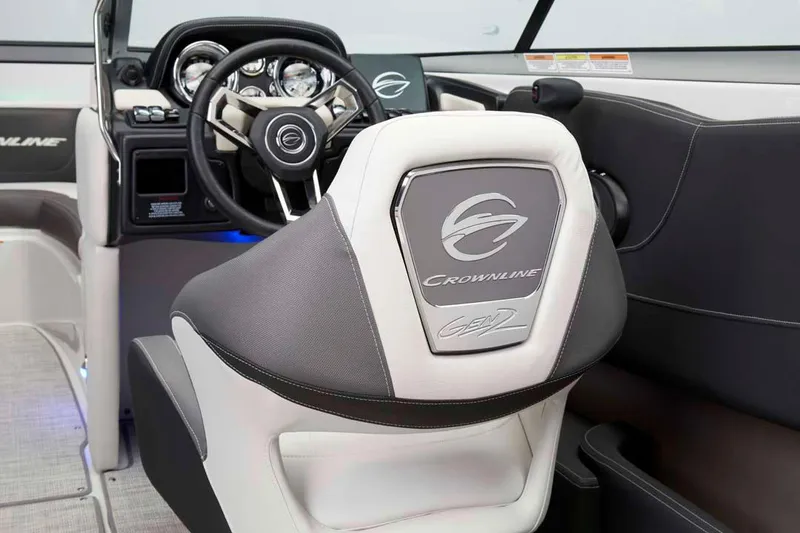 Slide: The Image of Manufacturer Provided Image: 2026 Crownline 200 SS boat interior with sleek steering wheel and branded seat design. - 16