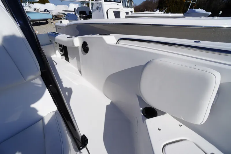 Slide: The Image of 2026 Tidewater 232 CC Adventure boat interior with white seating and sleek design. - 23