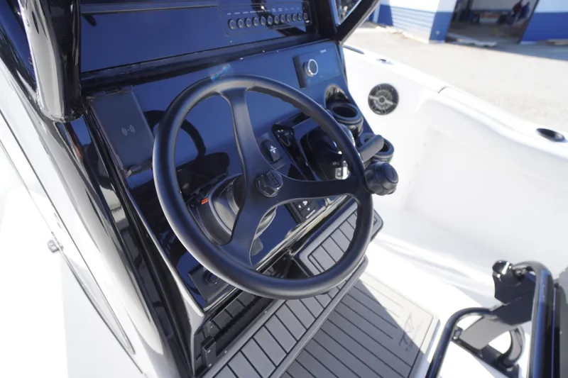 Slide: The Image of Steering console of 2026 Tidewater 232 CC Adventure boat, featuring modern controls. - 28