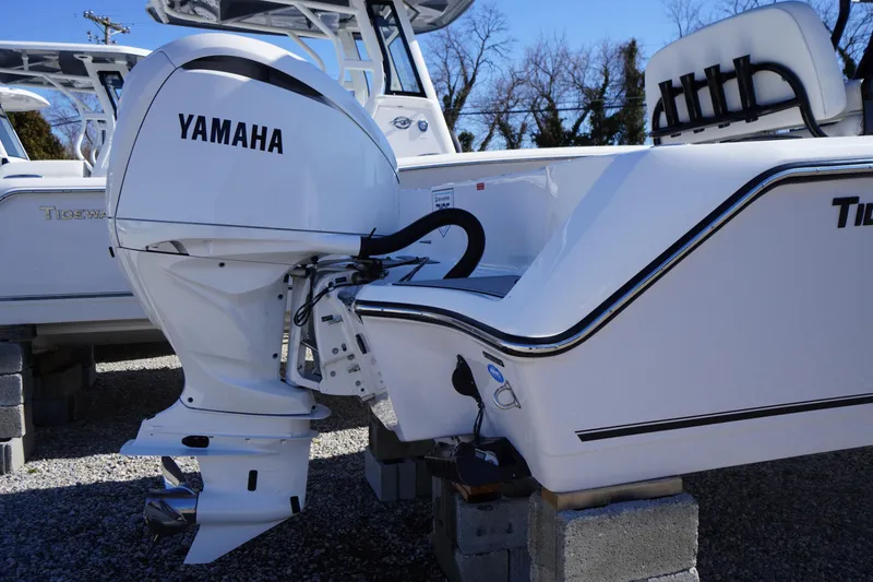 Slide: The Image of 2026 Tidewater 232 CC Adventure boat with Yamaha outboard motor, displayed on blocks. - 57
