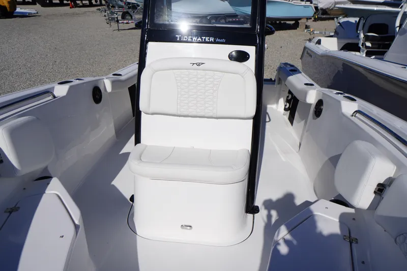 Slide: The Image of 2026 Tidewater 232 CC Adventure boat interior with white seating and console. - 17