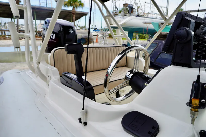 Slide: The Image of 2002 AB Inflatables Nautilus 11 DLX boat interior with steering wheel and Garmin equipment. - 5