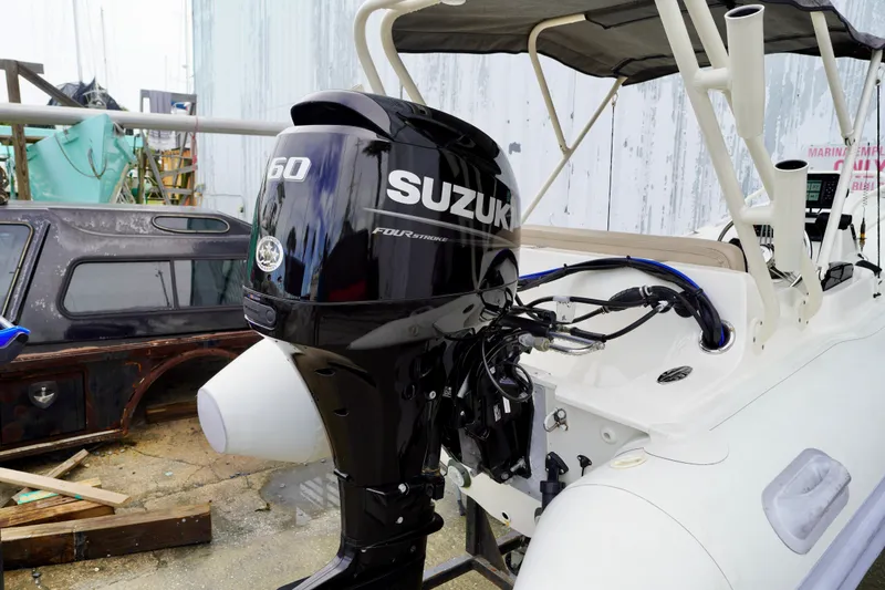Slide: The Image of 2002 AB Inflatables Nautilus 11 DLX with Suzuki 60 outboard motor in a boatyard. - 19