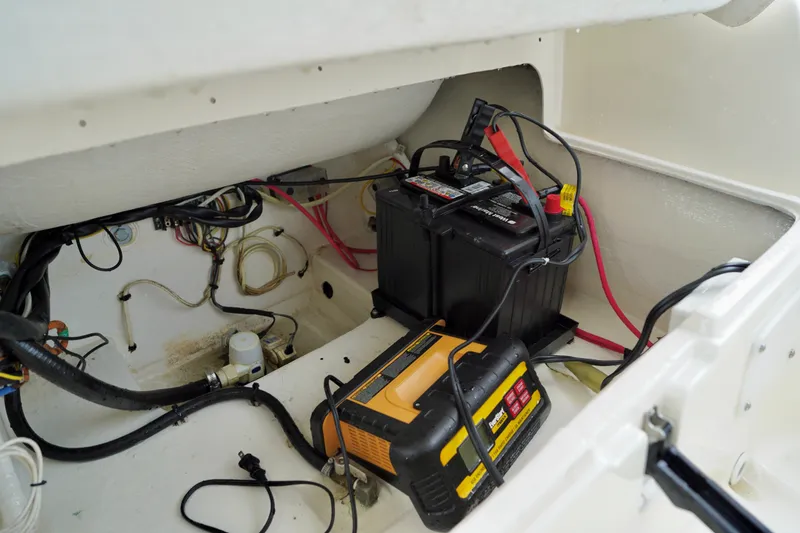 Slide: The Image of Battery compartment of a 2002 AB Inflatables Nautilus 11 DLX boat, showing wiring and charger. - 14