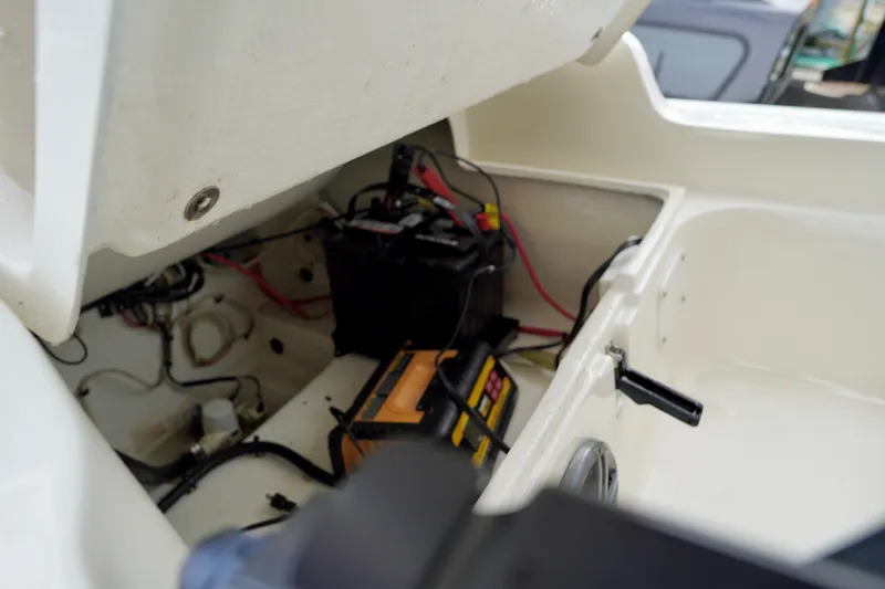 Slide: The Image of 2002 AB Inflatables Nautilus 11 DLX boat interior showing battery compartment and wiring. - 13