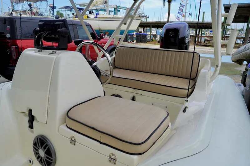 Slide: The Image of 2002 AB Inflatables Nautilus 11 DLX boat interior with beige seating and steering console. - 15