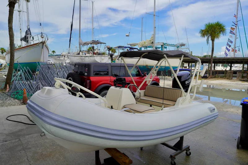 Slide: The Image of 2002 AB Inflatables Nautilus 11 DLX boat in marina with sailboats and palm trees. - 22