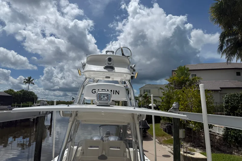 Slide: The Image of 2014 Intrepid 327 Center Console boat docked under cloudy sky. - 4