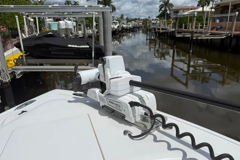 Slide: The Image of 2014 Intrepid 327 Center Console with Minn Kota motor in a scenic canal setting. - 9