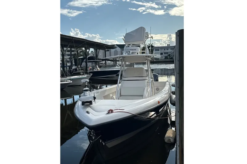 The Image of 2014 Intrepid 327-I CC boat docked at marina under clear sky. - 0
