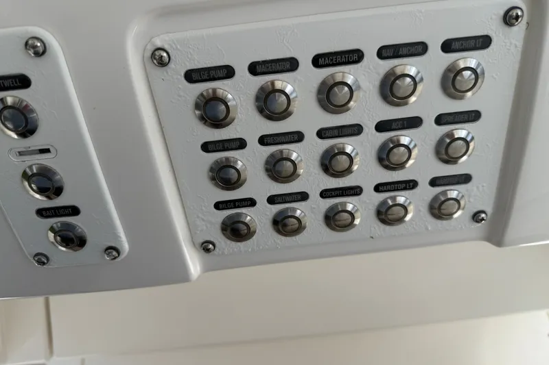 Slide: The Image of Control panel of a 2014 Intrepid 327 Center Console boat with labeled buttons. - 24