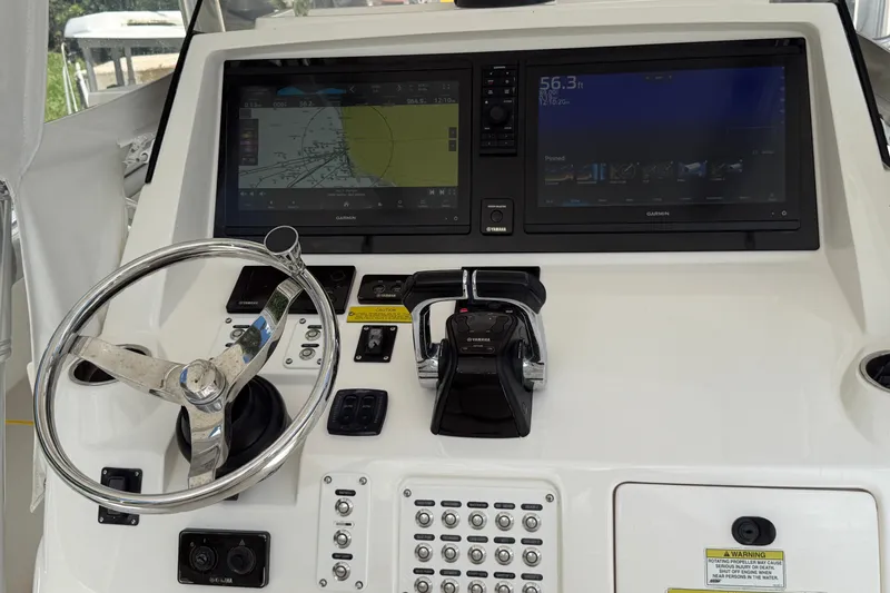 Slide: The Image of Control panel of a 2014 Intrepid 327 Center Console boat with Garmin displays. - 21